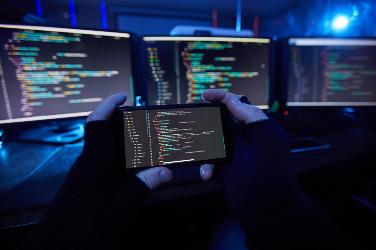 Computer hacker taking a photo on the phone